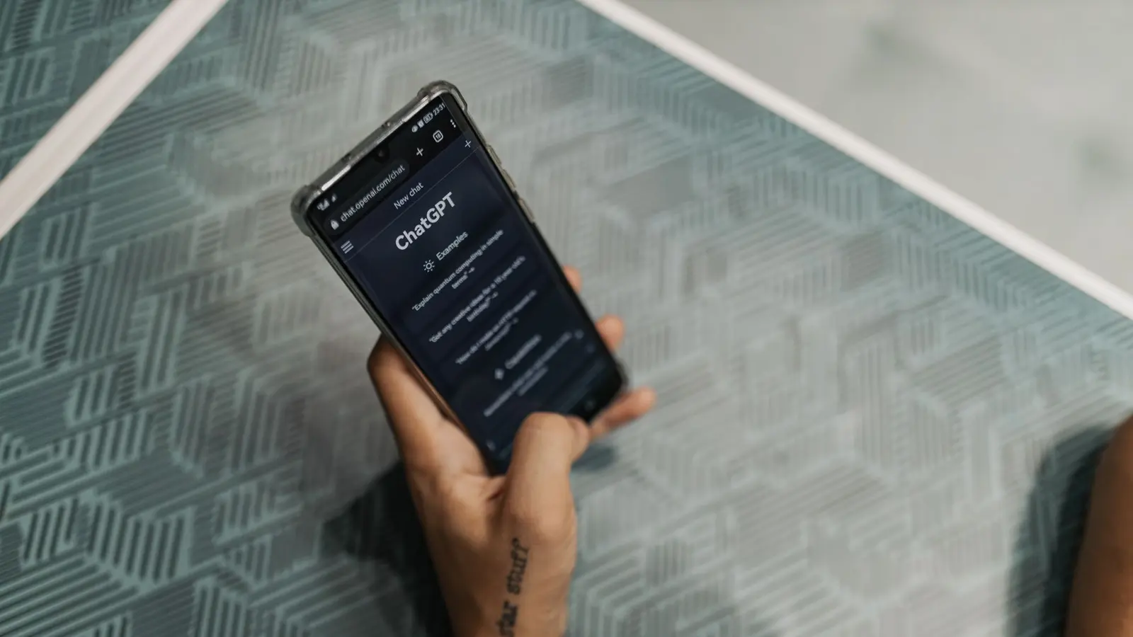 A person holding a smartphone showing the ChatGPT app, one of the AI answer engines buyers now ask for recommendations