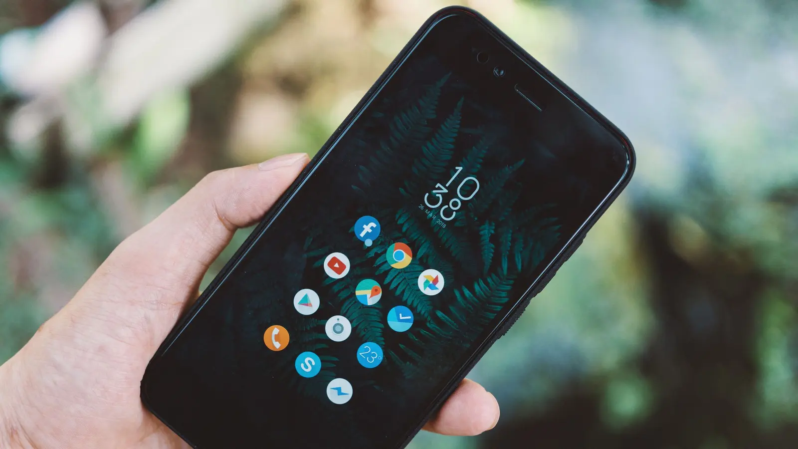 Hands holding a smartphone showing an app interface