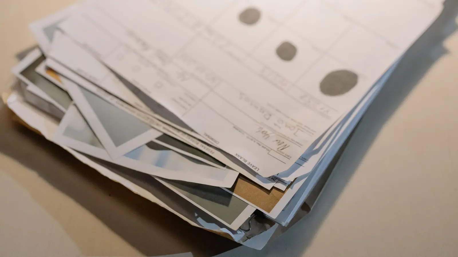 A stack of paper documents representing manual admin work