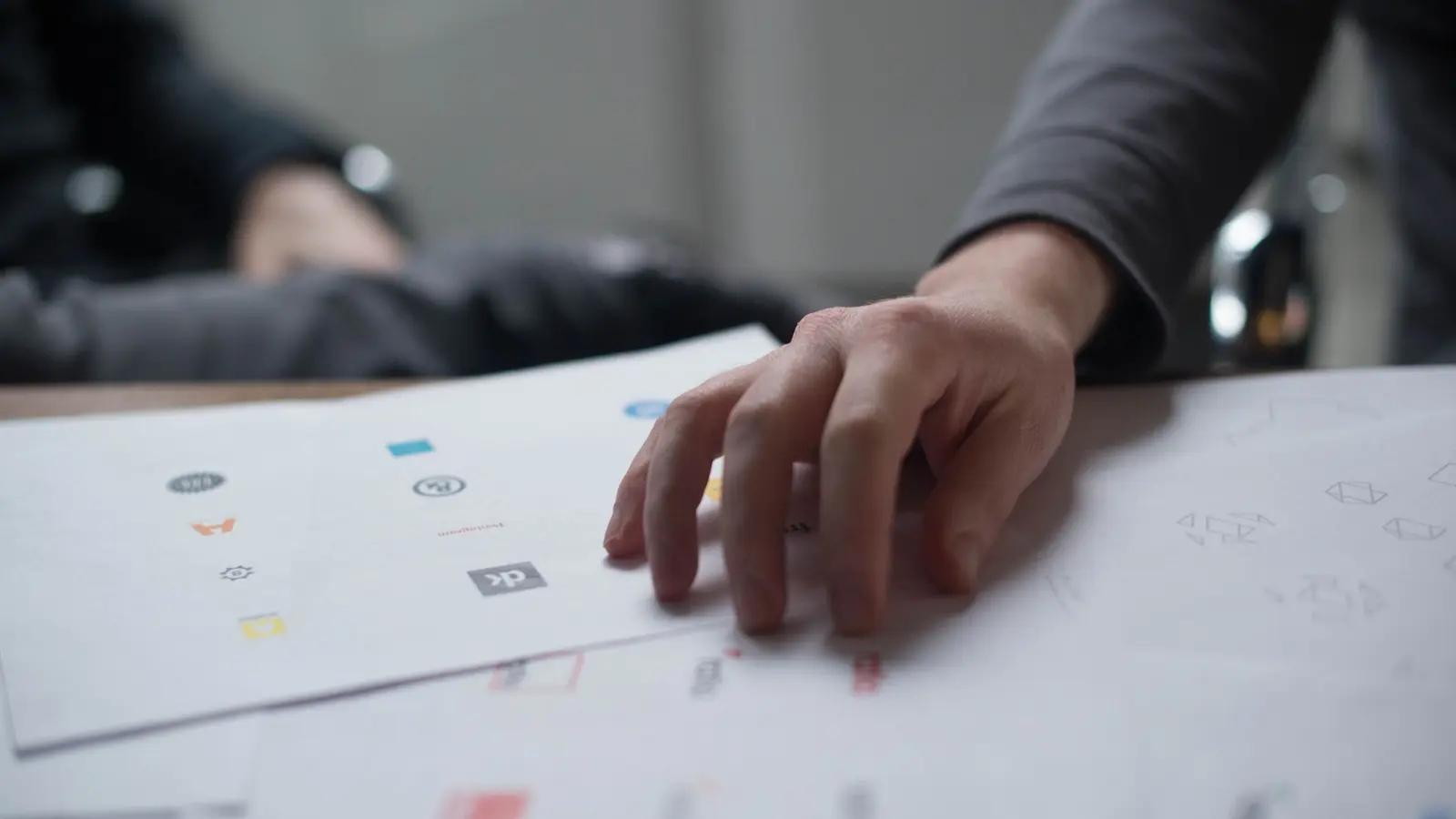 A creative team reviewing ad designs together on a table
