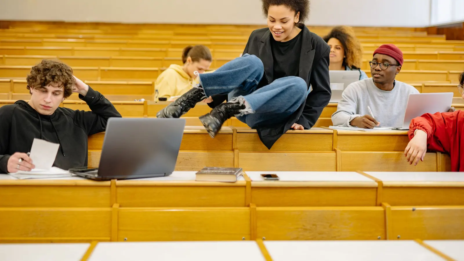 People learning with laptops open in a classroom setting
