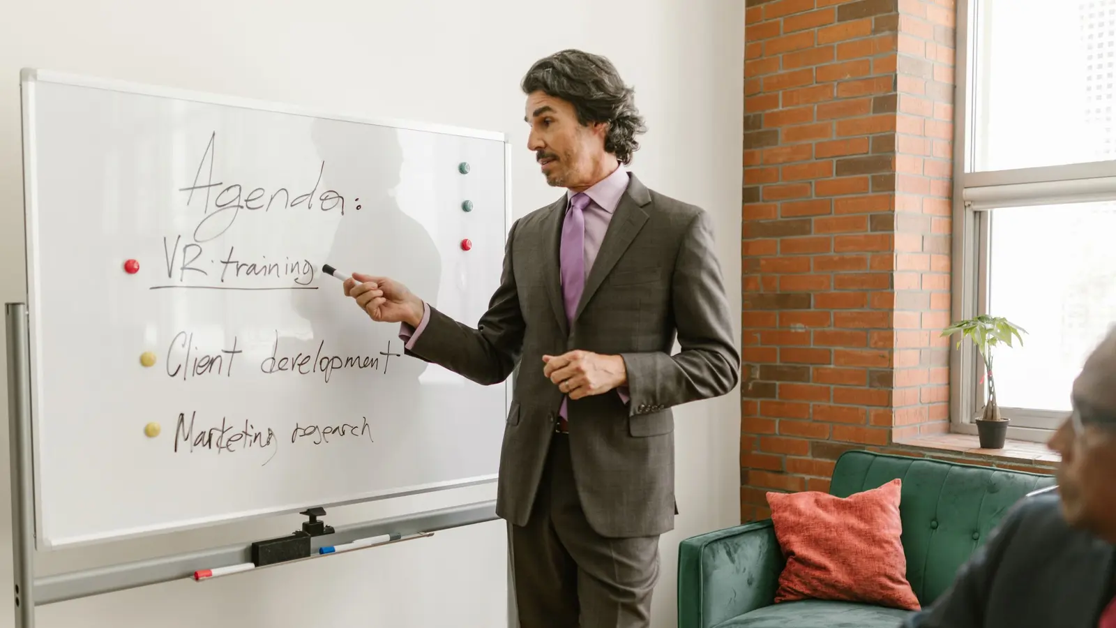 A trainer working through a plan at a whiteboard