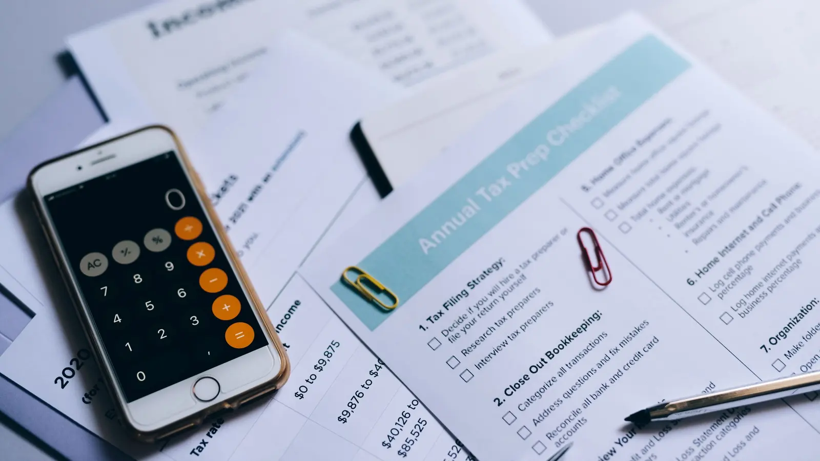 A desk with receipts, a notebook and a calculator during bookkeeping