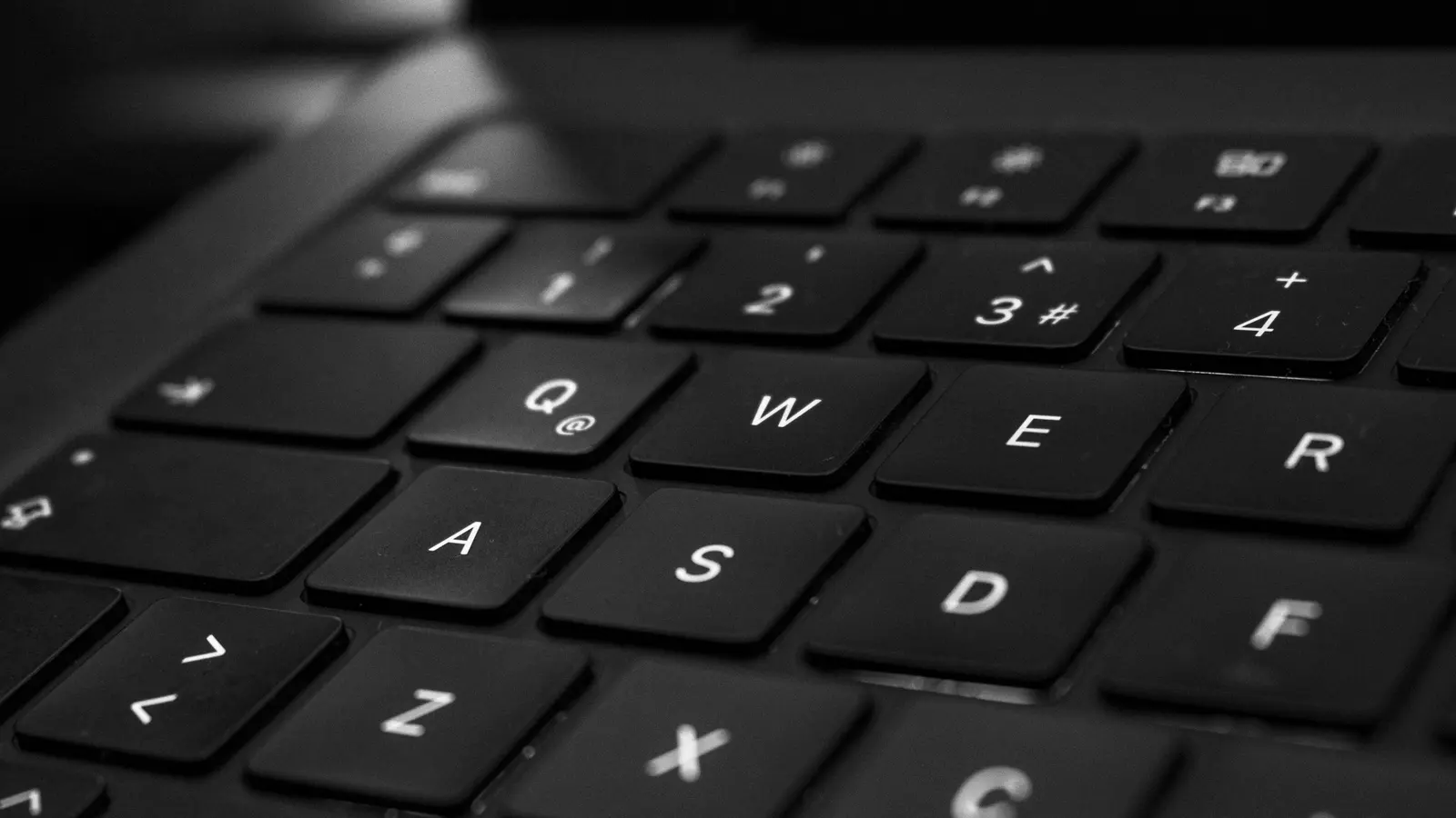 A close-up of a backlit computer keyboard