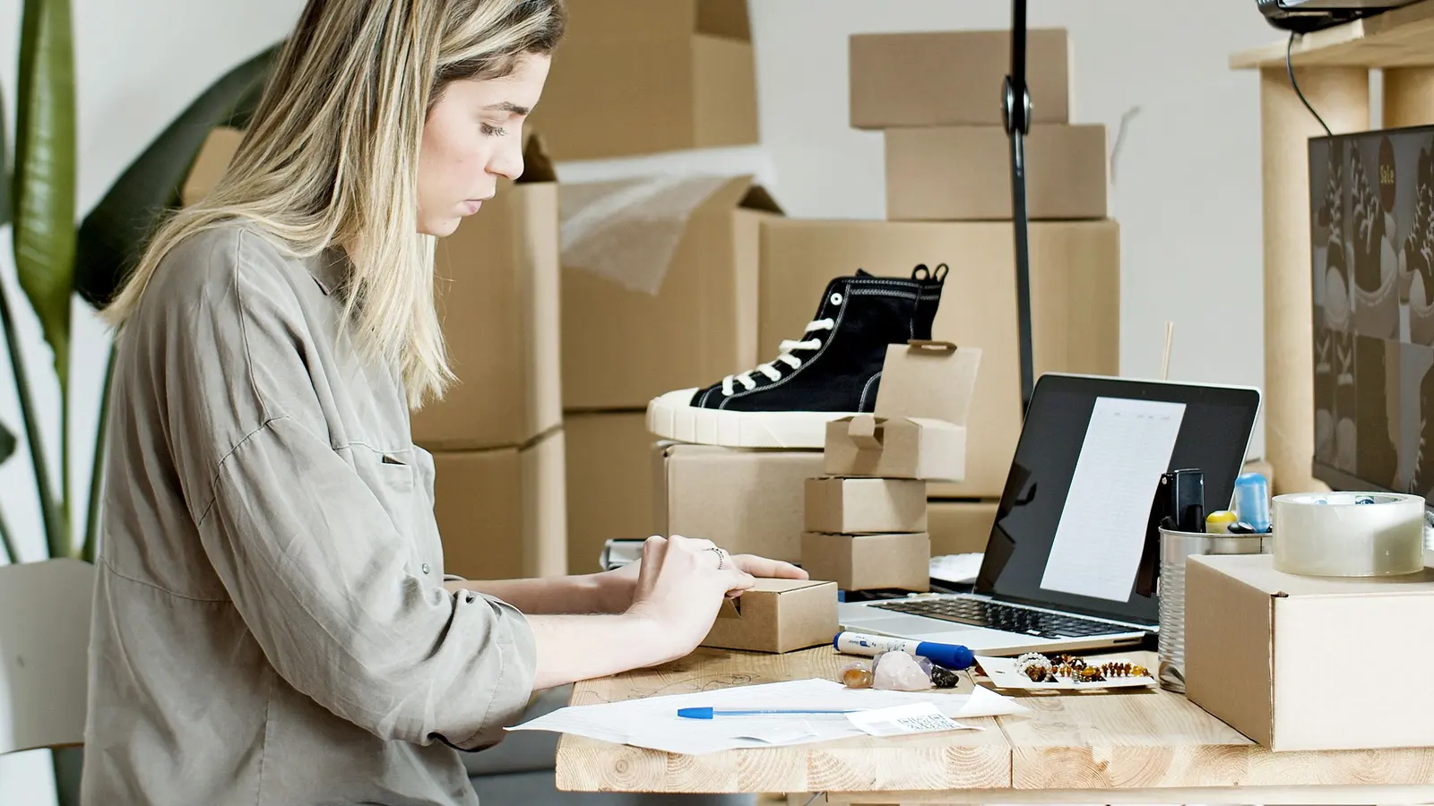 A store owner packing online orders into boxes