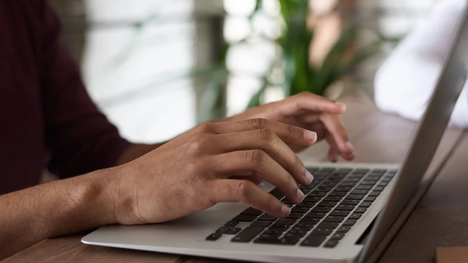 A person writing a newsletter on a laptop