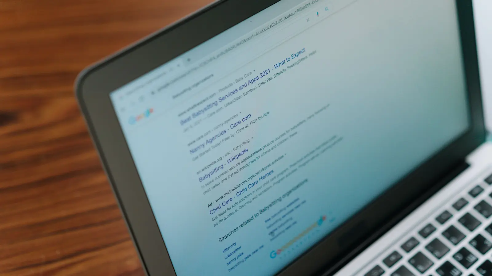 A laptop showing a search results page with paid ads above the organic listings