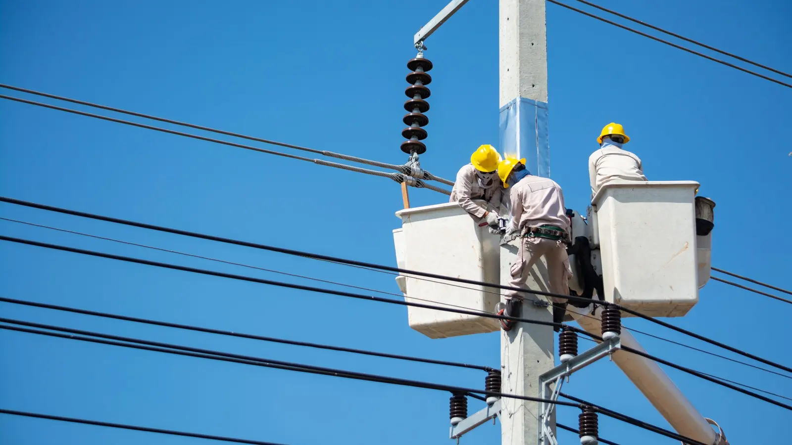 An electrician working on a switchboard at a job site