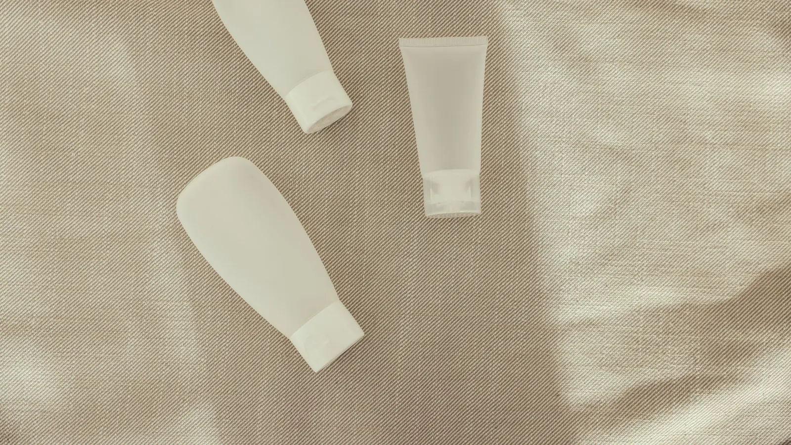 Minimal product bottles arranged on a textured surface