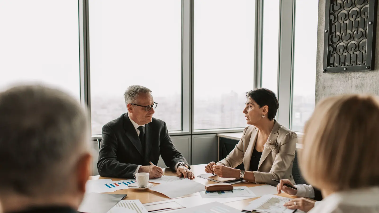 A boardroom meeting with decision makers around a table