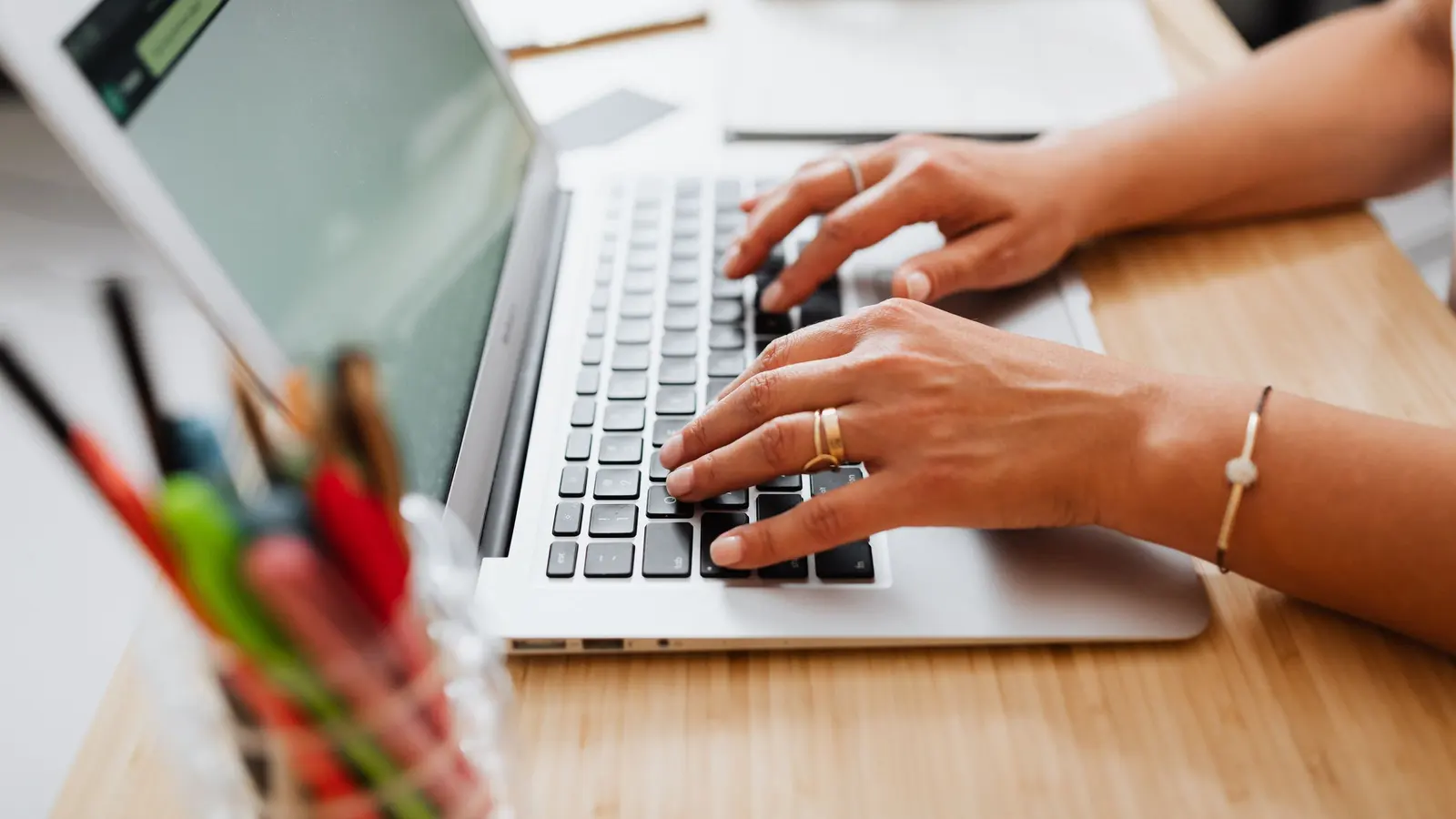 Someone writing website content on a laptop at a desk