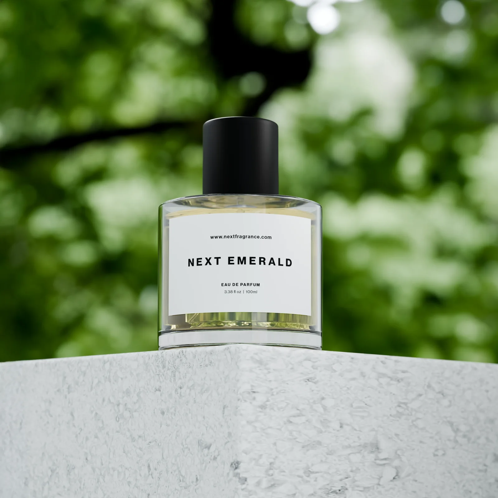 Next Emerald bottle on a stone ledge against sunlit green foliage
