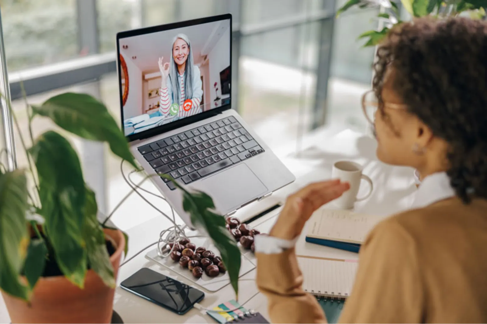 Student on a video call with a tutor at a bright home desk